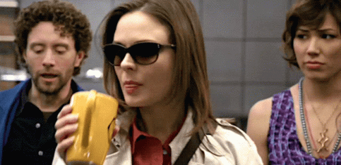 Woman in Sunglasses Holding Yellow Object