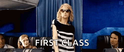 Woman in Sunglasses in First Class Airplane Seat