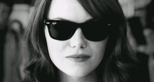 Woman In Sunglasses Making Face In Black And White GIF