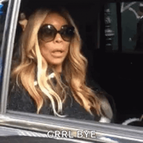 Woman in Sunglasses Mouth Open in Car