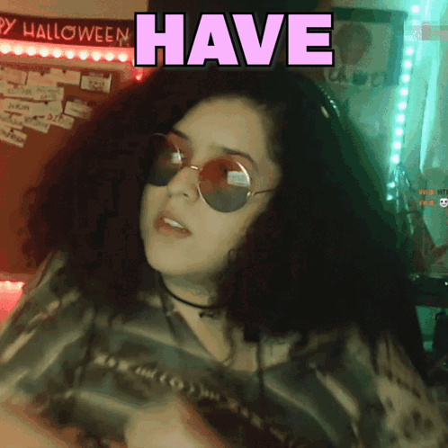 Woman in Sunglasses Saying Have