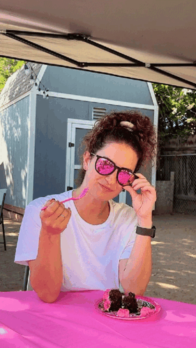 Woman in Sunglasses Sitting at Table With Food