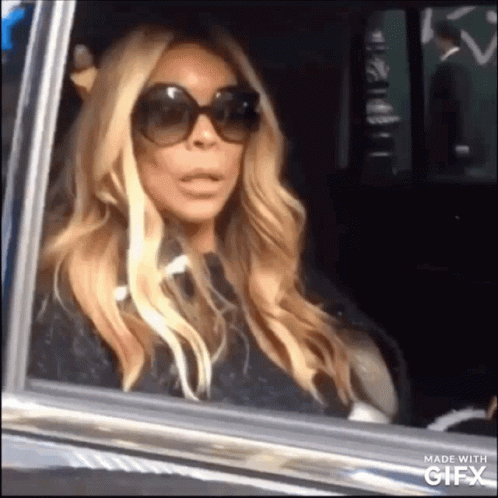 Woman in Sunglasses Sitting in Car