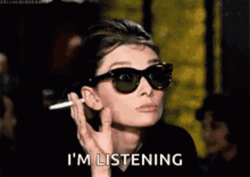 Woman In Sunglasses Smoking Cigarette Saying I'm Listening GIF