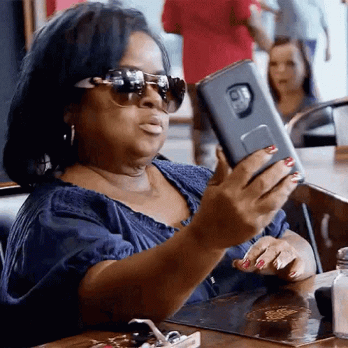 Woman in Sunglasses Taking Selfie
