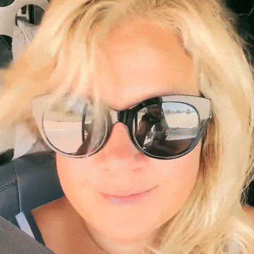 Woman in Sunglasses Taking Selfie in Mirror