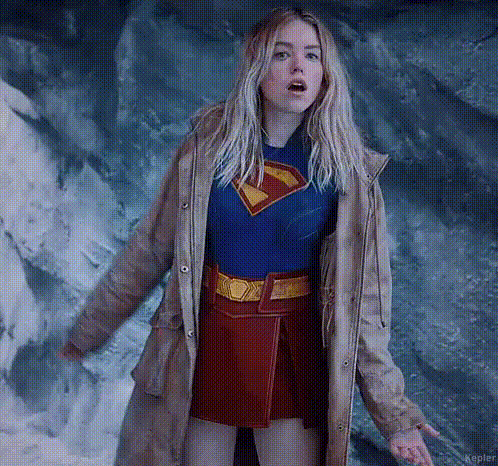 Woman In Superman Costume And Trench Coat GIF