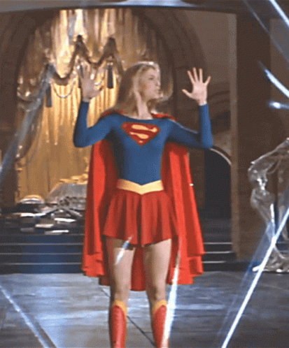 Woman In Superman Costume Before Chandelier GIF