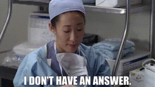 Woman in Surgical Gown Holding Paper Saying I Don't Have an Answer