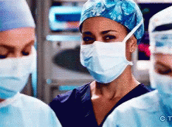 Woman in Surgical Mask Blue Hat Two Surgeons