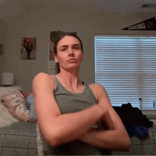 Woman in Tank Top Crossing Arms at Blinds