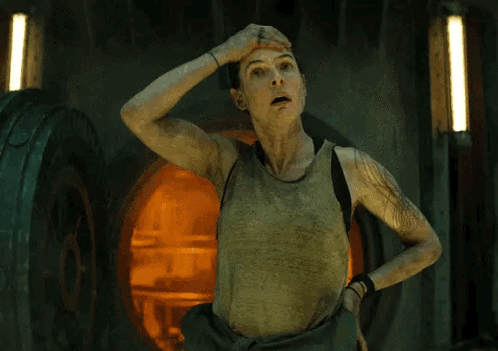 Woman in Tank Top Hand on Head in Dark Room