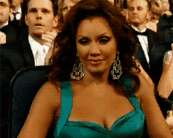 Woman in Teal Dress Sitting in Crowd