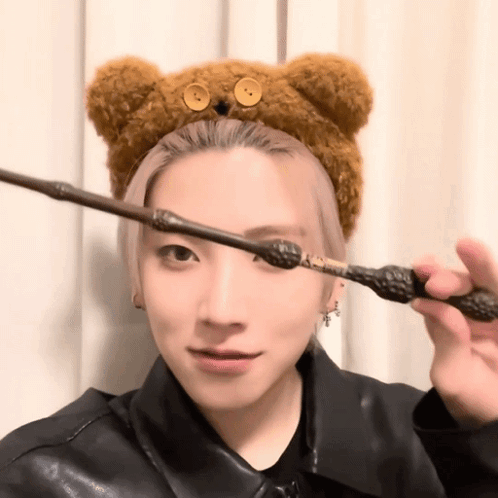 Woman In Teddy Bear Headband Holding Wand GIF