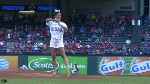 Woman in Texas Shirt Throws Baseball