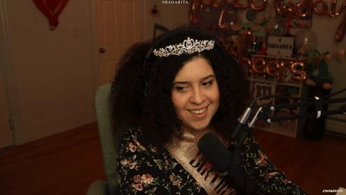 Woman In Tiara And Bride Sash Smiling At Microphone GIF