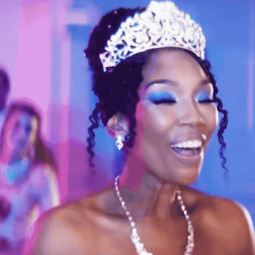 Woman In Tiara And Pearl Necklace Smiling GIF