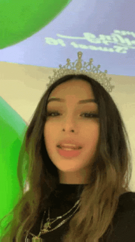 Woman in Tiara at Green Wall