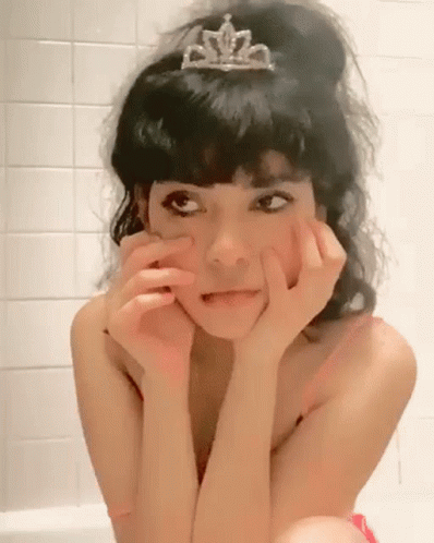Woman in Tiara Sitting in Bathtub Making Funny Face