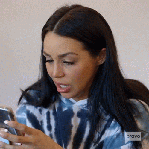 Woman in Tie Dye Hoodie Looking at Phone