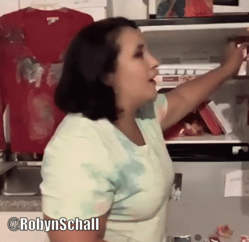 Woman in Tie Dye Shirt Reaching Into Fridge
