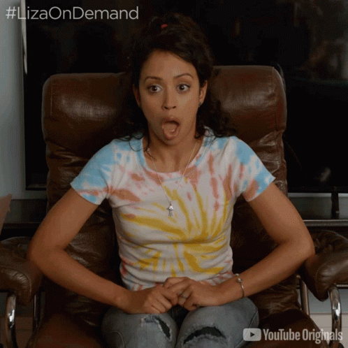 Woman In Tie Dye Shirt Sitting With Mouth Open YouTube Originals GIF