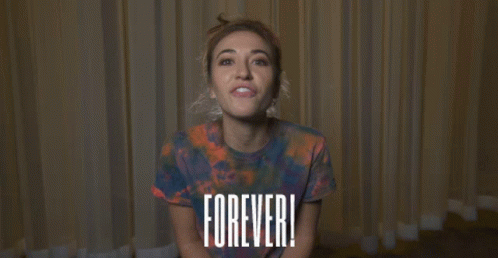Woman In Tie-Dye Shirt With Forever Sign GIF