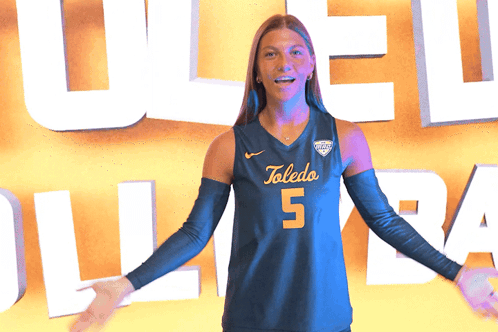 Woman in Toledo Jersey Holding Volleyball