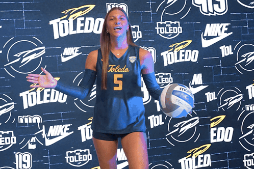 Woman in Toledo Jersey Holding Volleyball