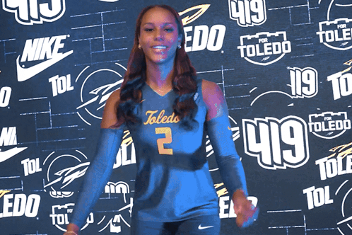 Woman in Toledo Jersey in Front of Nike and Toledo Logos
