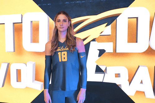 Woman in Toledo Volleyball Jersey in Front of Sign