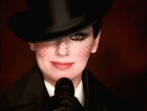 Woman in Top Hat and Veil Smiling
