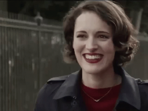 Woman in Trench Coat and Red Sweater Smiling