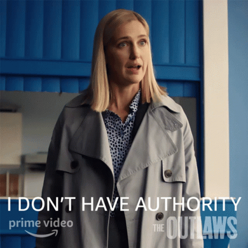 Woman in Trench Coat I Don't Have Authority
