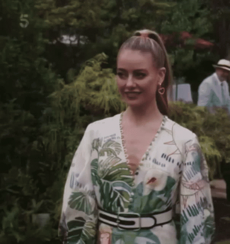 Woman in Tropical Print Dress With Number 5