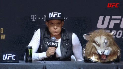 Woman in UFC Hat Sitting at Table