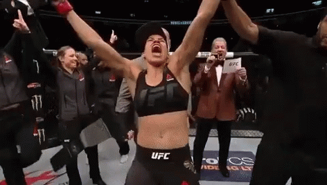 Woman in UFC Top Holding Arms Up