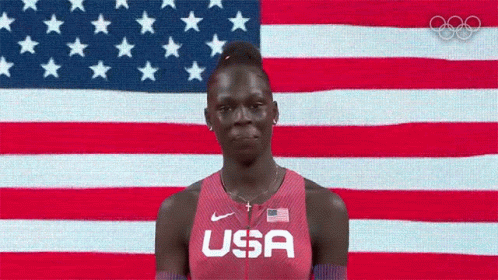 Woman in USA Shirt Before American Flag
