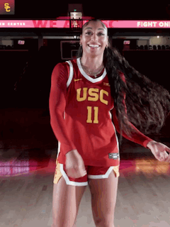 Woman in USC Jersey Dancing on Basketball Court