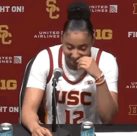 Woman in USC Jersey Sitting at Table With Microphone