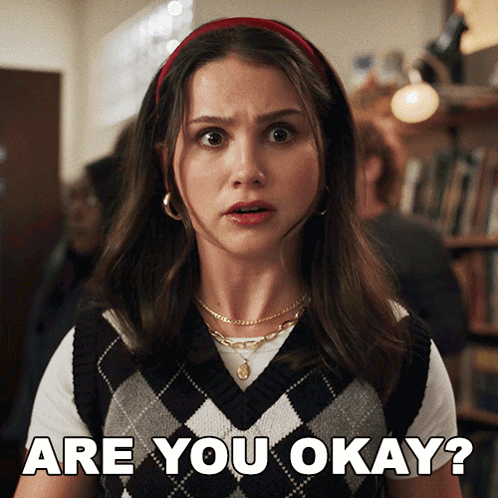 Woman in Vest and Headband Says Are You Okay