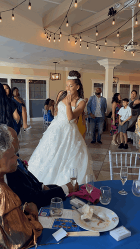 Woman in Wedding Dress From Table With Blue Tablecloth
