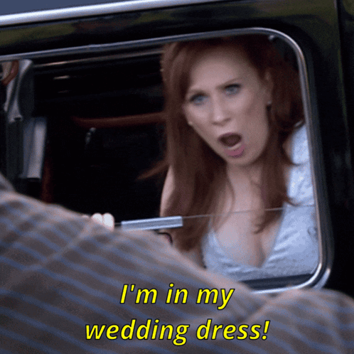 Woman in Wedding Dress Talking to Man