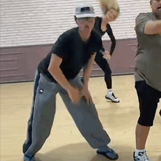Woman in Wheelchair Dancing With Man in Front of DWTS Sign