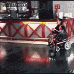 Woman in Wheelchair Riding Scooter in Restaurant