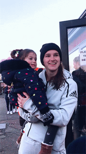 Woman In White Adidas Jacket Holding Girl GIF