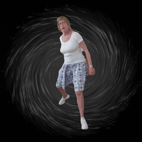Woman in White and Blue Dancing in Dark Room