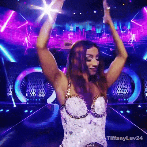 Woman in White and Gold Dress Dancing on Stage