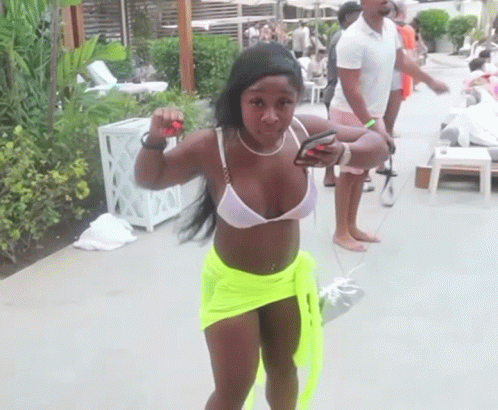 Woman in White Bikini and Neon Green Shorts by Pool