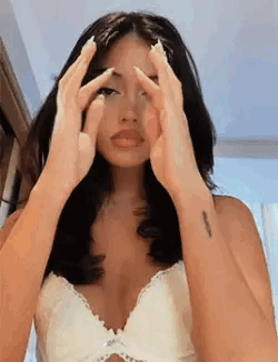 Woman in White Bra Covering Face With Hands